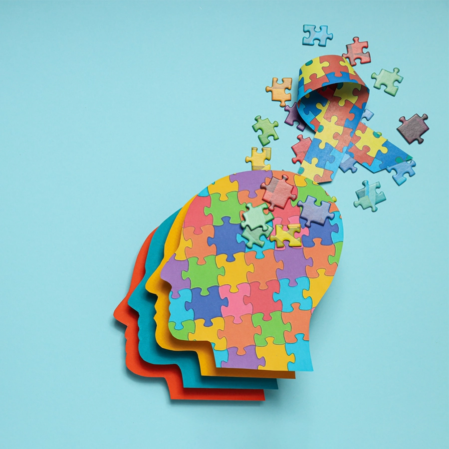 Human head made of colorful puzzle pieces with some dissolving.