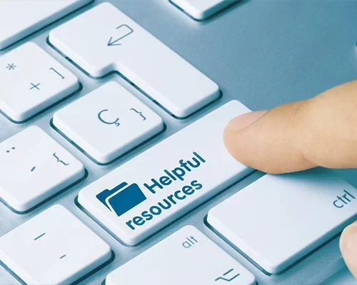 A finger pressing a keyboard key labeled 'Helpful resources'.